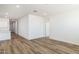 Open-concept living space features wood-look flooring and neutral walls at 17778 W Turquoise Ave, Waddell, AZ 85355
