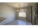 Cozy dining area with chandelier lighting and neutral walls, adjacent to a large window at 1831 S Hudson Dr, Chandler, AZ 85286