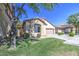 Charming single-story home with lush green lawn, mature tree, and a two-car garage at 1831 S Hudson Dr, Chandler, AZ 85286