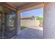 Covered patio boasts a brick floor and a view of the yard and a block fence at 1831 S Hudson Dr, Chandler, AZ 85286