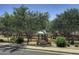 Neighborhood playground has swings and slides for recreational activities surrounded by mature trees at 1831 S Hudson Dr, Chandler, AZ 85286