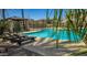 Community pool area provides a tranquil setting with lounge chairs, tables, and shaded seating at 1831 S Hudson Dr, Chandler, AZ 85286