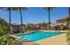Community pool offers a relaxing outdoor space with lounge chairs, shade, and mature landscaping at 1831 S Hudson Dr, Chandler, AZ 85286