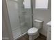 Bathroom showcasing a glass-enclosed shower, toilet and wood-look tile flooring at 18361 W Jessie Ln, Surprise, AZ 85387