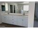 Bathroom with double sink vanity with mirror, drawers, and cabinets at 18361 W Jessie Ln, Surprise, AZ 85387
