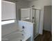 Corner bathtub and glass enclosed shower with window at 18361 W Jessie Ln, Surprise, AZ 85387