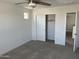 A bedroom with a ceiling fan, a closet, and an entry to the upper level at 18361 W Jessie Ln, Surprise, AZ 85387
