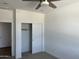 Bedroom featuring a ceiling fan, neutral carpet, closet and a door leading to another room at 18361 W Jessie Ln, Surprise, AZ 85387
