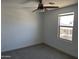 Clean and bright bedroom with ceiling fan and window overlooking the neighborhood at 18361 W Jessie Ln, Surprise, AZ 85387