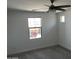 Bright bedroom with window and ceiling fan at 18361 W Jessie Ln, Surprise, AZ 85387
