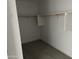 A walk-in closet with gray carpet and a shelf with a bar for hanging clothes at 18361 W Jessie Ln, Surprise, AZ 85387