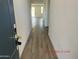 Inviting entryway with wood-look tile flooring leading into the bright and airy living spaces at 18361 W Jessie Ln, Surprise, AZ 85387
