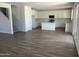 Open-concept kitchen featuring white cabinets, an island, and modern appliances at 18361 W Jessie Ln, Surprise, AZ 85387