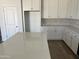 Kitchen showcasing white cabinets, quartz counters and wood-look tile flooring at 18361 W Jessie Ln, Surprise, AZ 85387