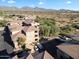 Aerial view of a condo community with tile roofs, parking, landscaping, and mountain views at 19777 N 76Th N St # 2243, Scottsdale, AZ 85255