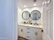 Bathroom with double sinks, quartz countertop, updated fixtures and stylish round mirrors at 19777 N 76Th N St # 2243, Scottsdale, AZ 85255