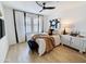 Bright bedroom with a ceiling fan, and a neatly made bed with stylish decor and wood floors at 19777 N 76Th N St # 2243, Scottsdale, AZ 85255
