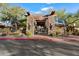Stone clubhouse entrance featuring wood beams and desert landscaping and lighting at 19777 N 76Th N St # 2243, Scottsdale, AZ 85255