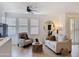 Cozy living room featuring a ceiling fan, plantation shutters and modern furniture at 19777 N 76Th N St # 2243, Scottsdale, AZ 85255