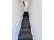 A straight carpeted stairway with gray walls and white railing at 19777 N 76Th N St # 2243, Scottsdale, AZ 85255