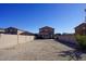Backyard featuring a dirt landscape, a patio, and a block wall fence at 19886 W Woodlands Ave, Buckeye, AZ 85326