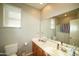 Bathroom featuring a double sink vanity, neutral paint, and a large mirror at 19886 W Woodlands Ave, Buckeye, AZ 85326