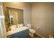 Stylish bathroom with blue vanity, decorative mirror, and modern fixtures at 19886 W Woodlands Ave, Buckeye, AZ 85326