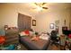 Bedroom featuring carpeted floors, ceiling fan, window, and a bed at 19886 W Woodlands Ave, Buckeye, AZ 85326