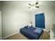 Comfortable bedroom with carpet flooring, ceiling fan, and bright window at 19886 W Woodlands Ave, Buckeye, AZ 85326