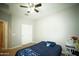 Neutral bedroom featuring carpeted floors, ceiling fan, and a closet at 19886 W Woodlands Ave, Buckeye, AZ 85326