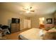 Bedroom featuring carpeted floors, windows, a ceiling fan, and a bed at 19886 W Woodlands Ave, Buckeye, AZ 85326