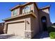 Charming home with a terracotta tile roof, a stone-accented garage, and a cozy front entry at 19886 W Woodlands Ave, Buckeye, AZ 85326