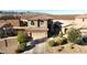 A charming two-story home featuring a terracotta tile roof and well-manicured landscaping at 19886 W Woodlands Ave, Buckeye, AZ 85326