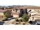 Aerial view of a stucco home with well-manicured front yard and a terracotta tile roof at 19886 W Woodlands Ave, Buckeye, AZ 85326