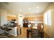 Spacious kitchen with stainless appliances, tile floors, and breakfast bar at 19886 W Woodlands Ave, Buckeye, AZ 85326