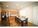 Well-lit kitchen with stainless steel refrigerator and adjacent dining space at 19886 W Woodlands Ave, Buckeye, AZ 85326