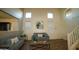 Inviting living room with high ceilings, neutral paint, and cozy couches at 19886 W Woodlands Ave, Buckeye, AZ 85326