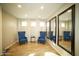 Cozy sitting room with neutral paint, tile floors, and three mirrors at 19886 W Woodlands Ave, Buckeye, AZ 85326