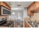 Efficient kitchen featuring granite countertops, stainless steel appliances, and wood cabinets at 200 E Southern Ave # 226, Tempe, AZ 85282