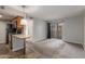 Open-concept living room featuring kitchen, carpeted flooring, and sliding glass door to balcony at 200 E Southern Ave # 226, Tempe, AZ 85282