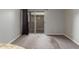 Living room with carpeted floors, gray walls, and sliding doors leading to an outdoor space at 200 E Southern Ave # 226, Tempe, AZ 85282