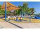 Colorful playground area with various musical play equipment and a shaded canopy, set on a soft, impact-absorbing surface at 200 E Southern Ave # 226, Tempe, AZ 85282
