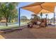 Colorful playground featuring natural wood and play equipment shaded by a canopy, nestled among trees at 200 E Southern Ave # 226, Tempe, AZ 85282