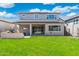 Green backyard with covered patio, large grassy area, and outdoor TV for entertaining at 21134 W Minnezona Ave, Buckeye, AZ 85396