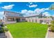 Spacious backyard with a green lawn, covered patio, and privacy fence at 21134 W Minnezona Ave, Buckeye, AZ 85396