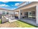 Backyard with covered patio, outdoor kitchen with grill, blue fire pit, patio furniture and green grass at 21134 W Minnezona Ave, Buckeye, AZ 85396