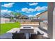 Inviting backyard with a built-in grill, fire pit, beautiful landscaping and patio seating at 21134 W Minnezona Ave, Buckeye, AZ 85396