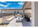 A backyard featuring a covered patio, outdoor kitchen, and a blue fire pit at 21134 W Minnezona Ave, Buckeye, AZ 85396