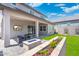 Well-manicured backyard with fire pit, flower bed, patio with outdoor television and lounge chairs at 21134 W Minnezona Ave, Buckeye, AZ 85396