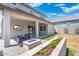 Backyard with covered patio, outdoor tv, blue fire pit, flower boxes, and green grass at 21134 W Minnezona Ave, Buckeye, AZ 85396